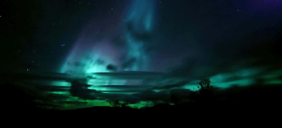 Abisko: Northern Lights Hike with Husky Puppies - Warming up inside the Sámi-style lávvú