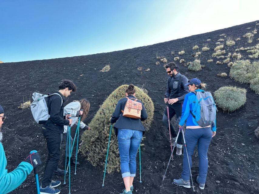 Catania: Etna Morning or Sunset Trek with Lava Tunnel & Gear - Entering the lava tube with a helmet and flashlight
