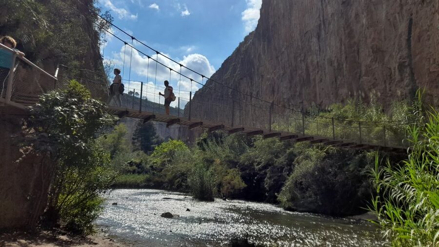 Chulilla: Hanging Bridges & Canyon Private Hiking Day Tour - Walking into the Turia River canyon
