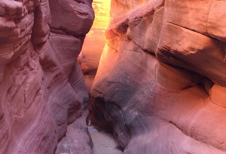 From Kanab: 3-Hour Peek-a-Boo Slot Canyon Hiking/Photo Tour - Walking through Peek-a-Boo’s colored stone